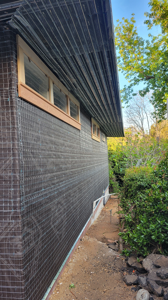 Exterior home renovation with new house wrap before stucco.