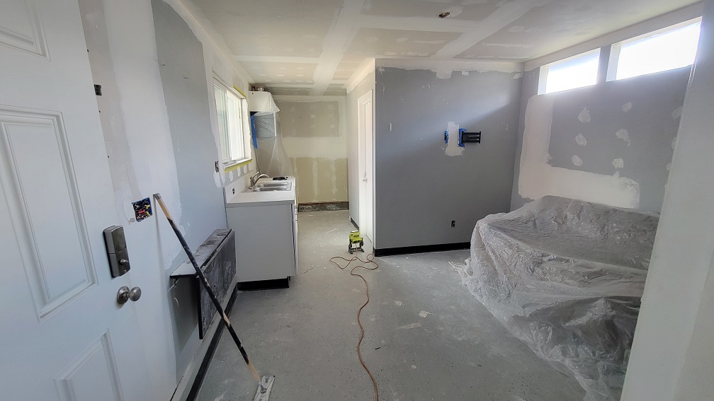 Drywall installation in progress during residential interior renovation.
