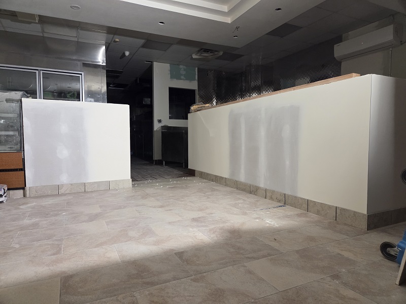 Commercial remodel in progress with new tile flooring and updated wall structures.