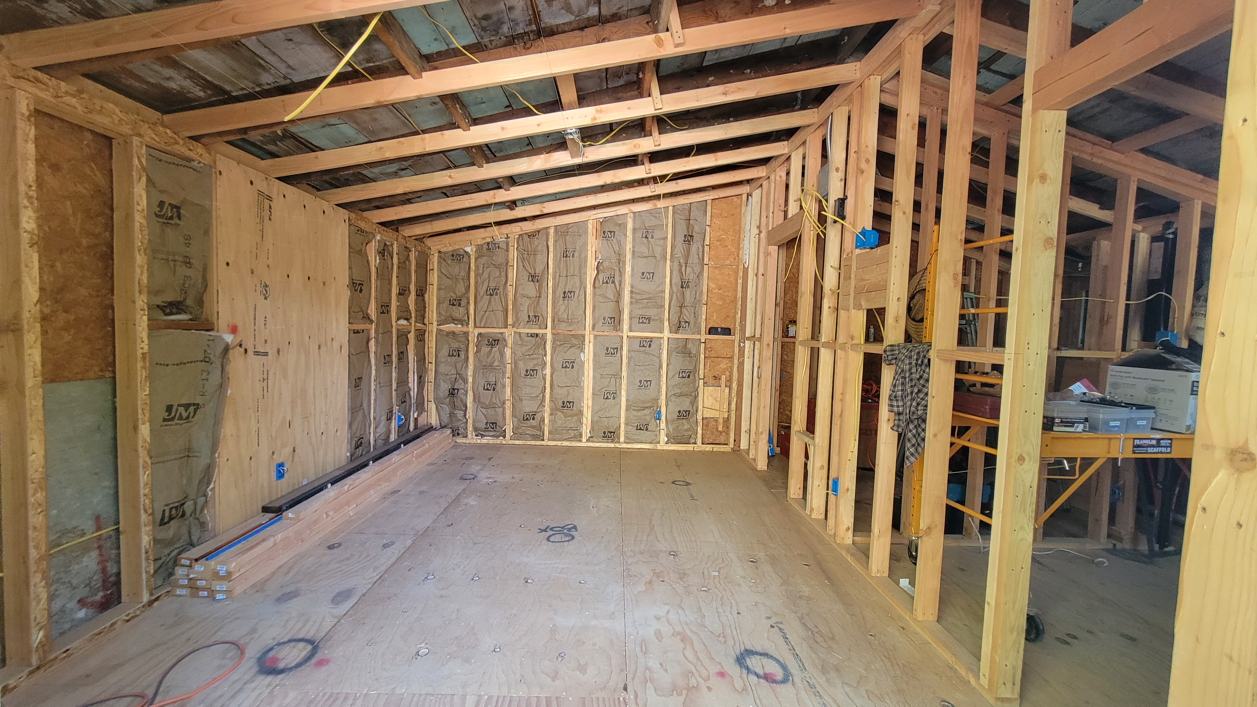 Garage or room addition framed with new lumber and structural supports.
