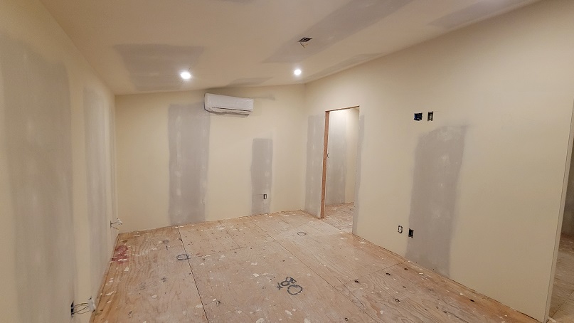 Drywall and interior framing during bedroom remodel with mini-split installation.
